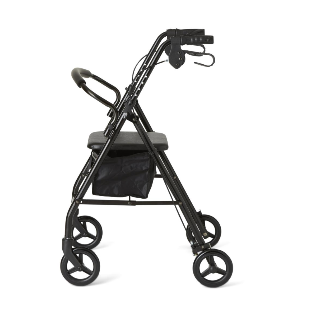 The Medline Basic Lightweight Steel Folding Rollator, shown in profile against a plain white background, is a black four-wheel mobility aid featuring height-adjustable handlebars, a seat, and an under-seat storage pouch.